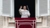 Pope Francis waves to faithful during the Angelus noon prayer in St. Peter's Square, at the Vatican, Jan. 6, 2022.