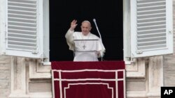 Pope Francis waves to faithful during the Angelus noon prayer in St. Peter's Square, at the Vatican, Jan. 6, 2022.