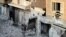 In this citizen journalism image taken on Saturday, July 28, 2012 and provided by Edlib News Network ENN, a Syrian family stand in the rubble of destroyed houses in Maarat al-Numaan on the eastern edge of Idlib province, northern Syria. 