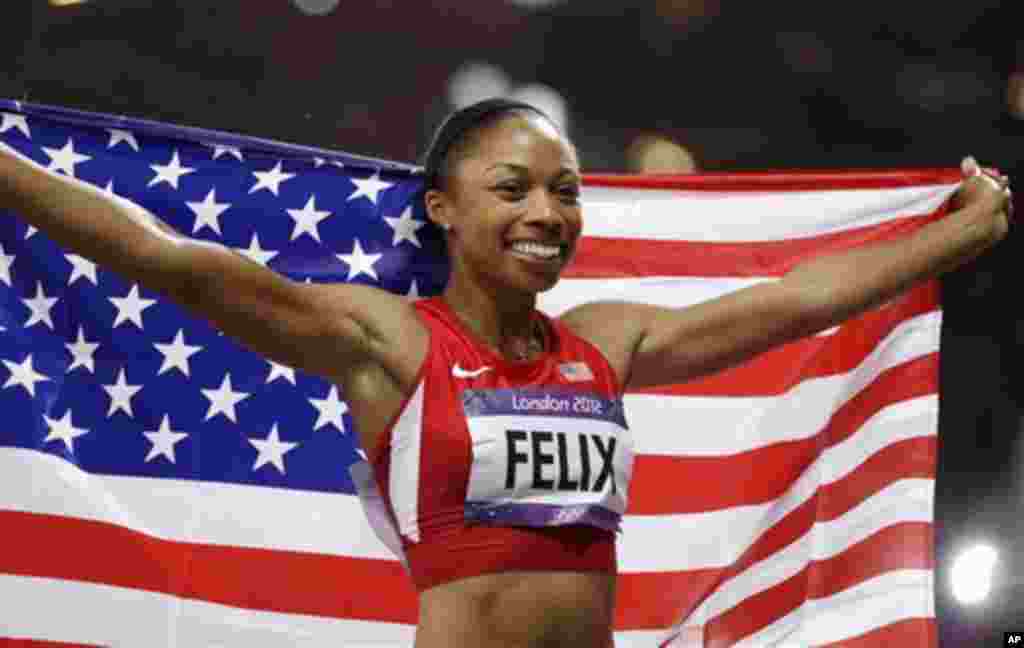United States' Allyson Felix celebrates winning gold in the women's 200-meter final during the athletics in the Olympic Stadium at the 2012 Summer Olympics, London, Wednesday, Aug. 8, 2012. (AP Photo/Ben Curtis)