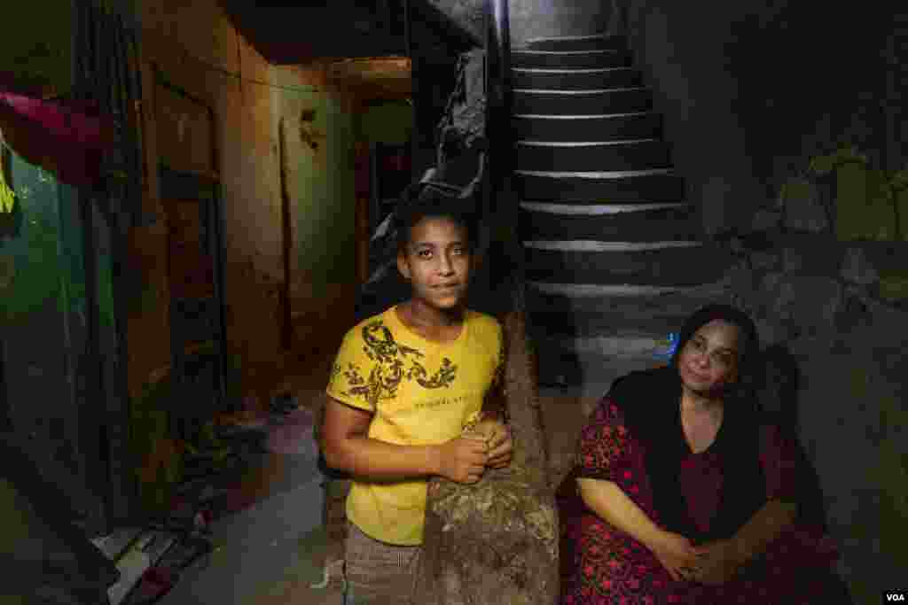 Mohamed Hamido, 14, left school to earn a living removing dust from housing demolition sites, as his single, diabetic mother cannot financially support their family of three, Cairo, Aug. 8, 2021. (Hamada Elrasam/VOA)