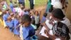 FILE - Schoolchildren line up for trachoma medicine in Buniantole, eastern Uganda, Sept. 12, 2012. (Hilary Heuler/VOA)