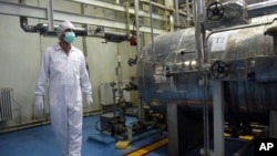 FILE - An Iranian technician walks through the Uranium Conversion Facility just outside the city of Isfahan, south of the capital Tehran, in this Feb. 2007 photo.