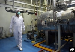 FILE - An Iranian technician walks through a uranium conversion facility just outside Isfahan, south of the capital, Tehran, in this February 2007 photo.