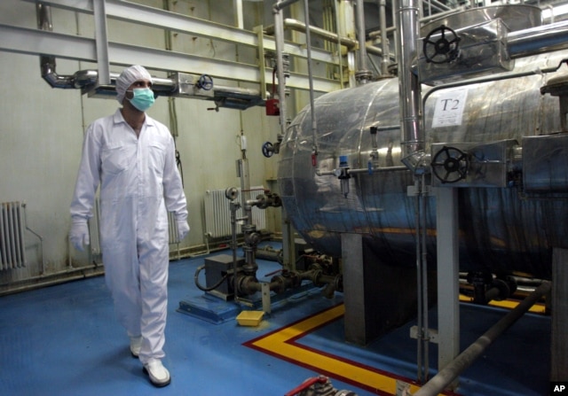 FILE - An Iranian technician walks through the Uranium Conversion Facility just outside the city of Isfahan, south of the capital Tehran.