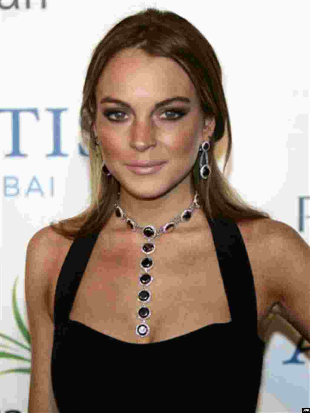 FILE - In this Nov. 20, 2008 file photo U.S. actress Lindsay Lohan arrives on the red carpet at the Atlantis hotel grand opening on Jumeirah Palm Island in Dubai, United Arab Emirates. (AP Photo/Kamran Jebreili, File)