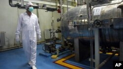 FILE - An Iranian technician walks through the Uranium Conversion Facility just outside the city of Isfahan, south of the capital Tehran.