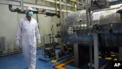 FILE - An Iranian technician walks through the Uranium Conversion Facility just outside the city of Isfahan, south of the capital Tehran.