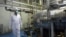 FILE - An Iranian technician walks through the Uranium Conversion Facility just outside the city of Isfahan, south of the capital Tehran.