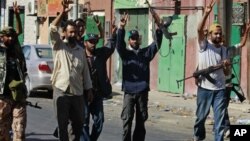 Libyan rebel fighters celebrate after taking partial control of the coastal town of Zawiya, 50 km (30 miles) west of Tripoli, August 14, 2011.