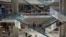 FILE - In this April 10, 2014 photo, people ride up and down the escalators inside the Sambil mall in Caracas, Venezuela. (AP Photo/Fernando Llano)