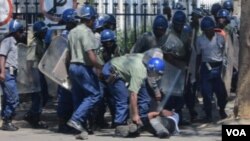 Police arrest a protester in Bulawayo following a planned demonstration in the city.