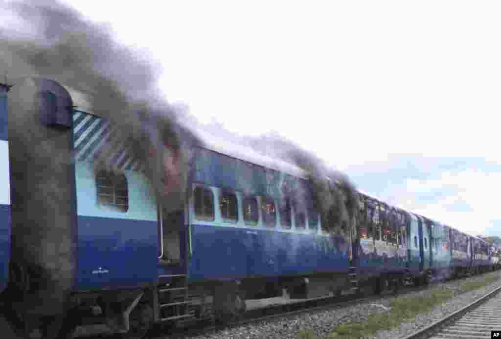 Coaches of the Rajya Rani Express train burn after a mob set it on fire after it ran over a group of Hindu pilgrims at a crowded station in Dhamara Ghat, Bihar state, India, August 19, 2013.
