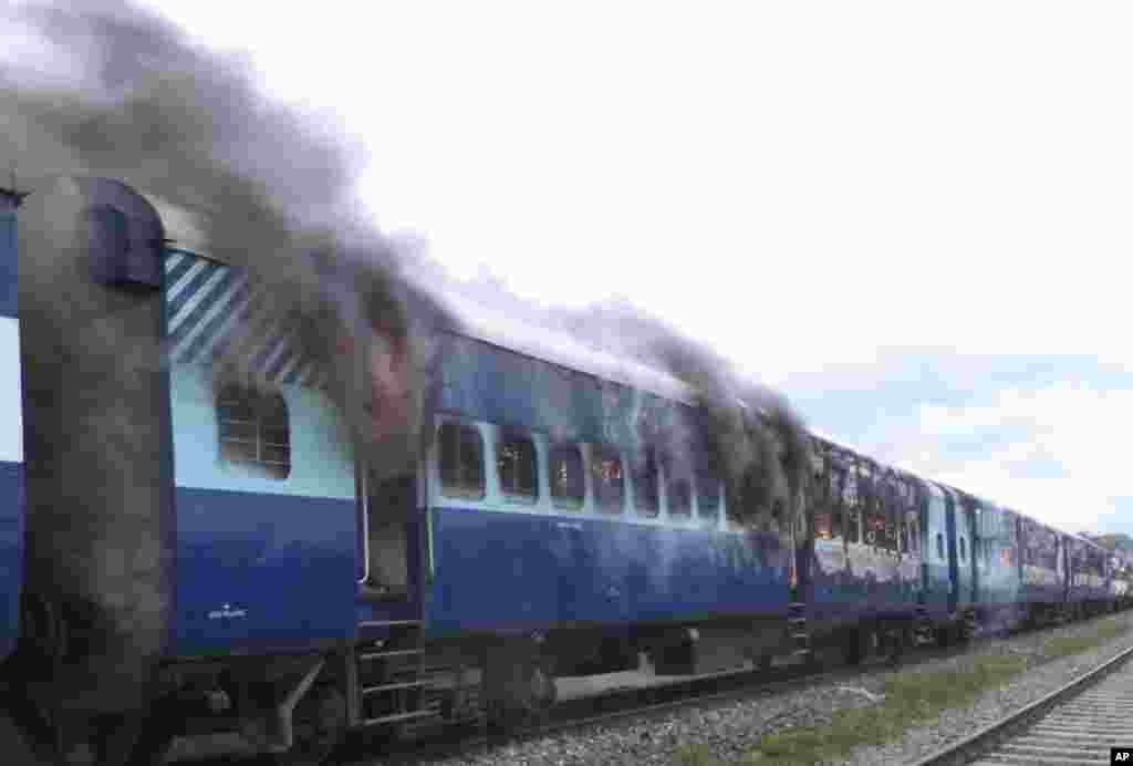 Coaches of the Rajya Rani Express train burn after a mob set it on fire after it ran over a group of Hindu pilgrims at a crowded station in Dhamara Ghat, Bihar state, India, August 19, 2013. 