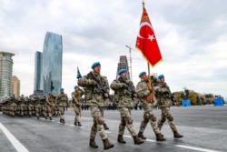 FILE - Members of a Turkish forces commando brigade take part in a military parade in which Turkey's President Recep Tayyip Erdogan and Azerbaijan's President Ilham Aliyev looked on in Baku, Azerbaijan, Dec. 10, 2020.
