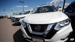 FILE - Rogue sports utility vehicles sit at a Nissan dealership in Highlands Ranch, Colorado, Aug. 25, 2019. 