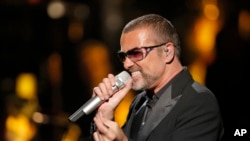 FILE - In this Sept. 9, 2012 photo, George Michael sings during a concert to raise money for the AIDS charity Sidaction, in Paris, France. 