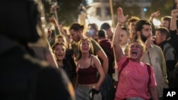 Demonstrators gather for a protest organized by social and civic groups, denouncing the handling of recent flooding under the slogan "Mazon, Resign," aimed at the president of the regional government Carlos Mazon, in Valencia, Spain, Nov. 9, 2024. 