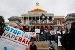 FILE - Demonstrators gather at the Massachusetts State House to protest the state’s four-month ban of all vaping product sales in Boston, Oct. 3, 2019.