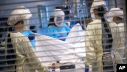 FILE - In this image provided by University of Utah Health, medical professionals look after a COVID-19 patient in the intensive care unit on July 30, 2021, in Salt Lake City.