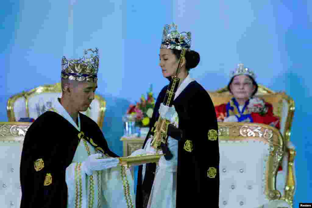 Reverend Hyung Jin Moon, the church&#39;s pastor and the son of the late Sun Myung Moon, attends a ceremony while people with their AR-15-style rifles in their cases watch the event at the Sanctuary Church in Newfoundland, Pennsylvania, Feb. 28, 2018.