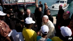 FILE - Pope Francis speaks to migrants during his visit to the island of Lampedusa, southern Italy, July 8, 2013. The pontiff traveled there to pray for migrants lost at sea.