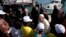 FILE - Pope Francis speaks to migrants during his visit to the island of Lampedusa, southern Italy, July 8, 2013. The pontiff traveled there to pray for migrants lost at sea.