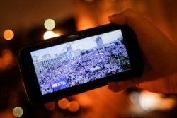 A man looks at Telegram channel NEXTA Live on his smartphone in Minsk, Belarus, Aug. 19, 2020.