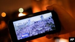 A man looks at Telegram channel NEXTA Live on his smartphone in Minsk, Belarus, Aug. 19, 2020. 