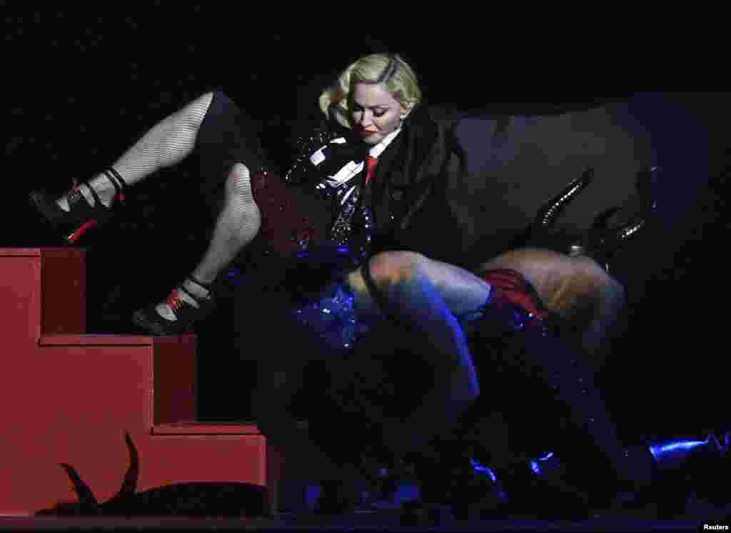 Singer Madonna falls during her performance at the BRIT music awards at the O2 Arena in Greenwich, London, Feb. 25, 2015.