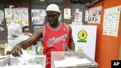 A man casts his vote during the local government election in Nigeria's commercial capital Lagos October 22, 2011.