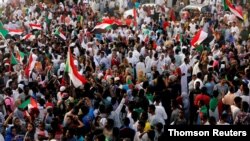 FILE - Sudanese people celebrate in Khartoum after the ruling military council and a coalition of opposition and protest groups reached agreement to share power during a transition period leading to elections, July 5, 2019. 