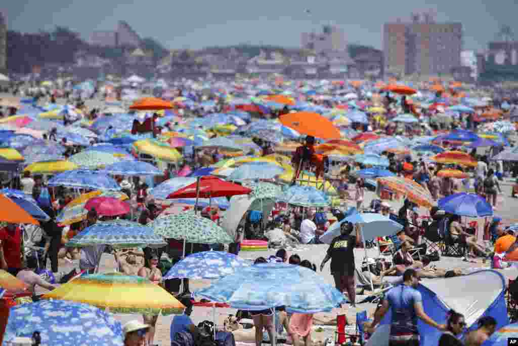 People enjoy the beach at Coney Island, July 4, 2020, in the Brooklyn borough of New York.