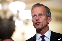 FILE - Sen. John Thune, R-S.D., speaks with reporters on Capitol Hill in Washington, Sept. 5, 2018.