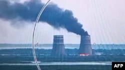 This video grab taken from a handout footage released by the Ukrainian Presidential Press Service on August 11, 2024, shows a fire at a cooling tower of the Russian-controlled Zaporizhzhia nuclear power plant in Energodar, Ukraine.