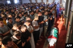 FILE - Mourners attend the funeral of Hamas member Zakaria Muammar, who was killed in an Israeli strike, in Khan Yunis on October 10, 2023.