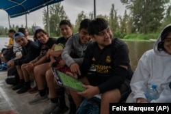 Amateur soccer players from the Tumbados team travel in a traditional canoe in the Xochimilco borough of Mexico City, on Sunday, October 20, 2024. (AP Photo/Felix Marquez)