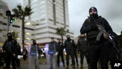 Police officers stand guard at the site of an explosion, in Izmir, Turkey, Jan. 5, 2017.