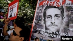 Refugees and protesters supporting Edward Snowden demonstrate outside the U.S. Consulate as they demand that U.S. President Barack Obama grant Snowden a pardon, in Hong Kong, China Sept. 25, 2016. 