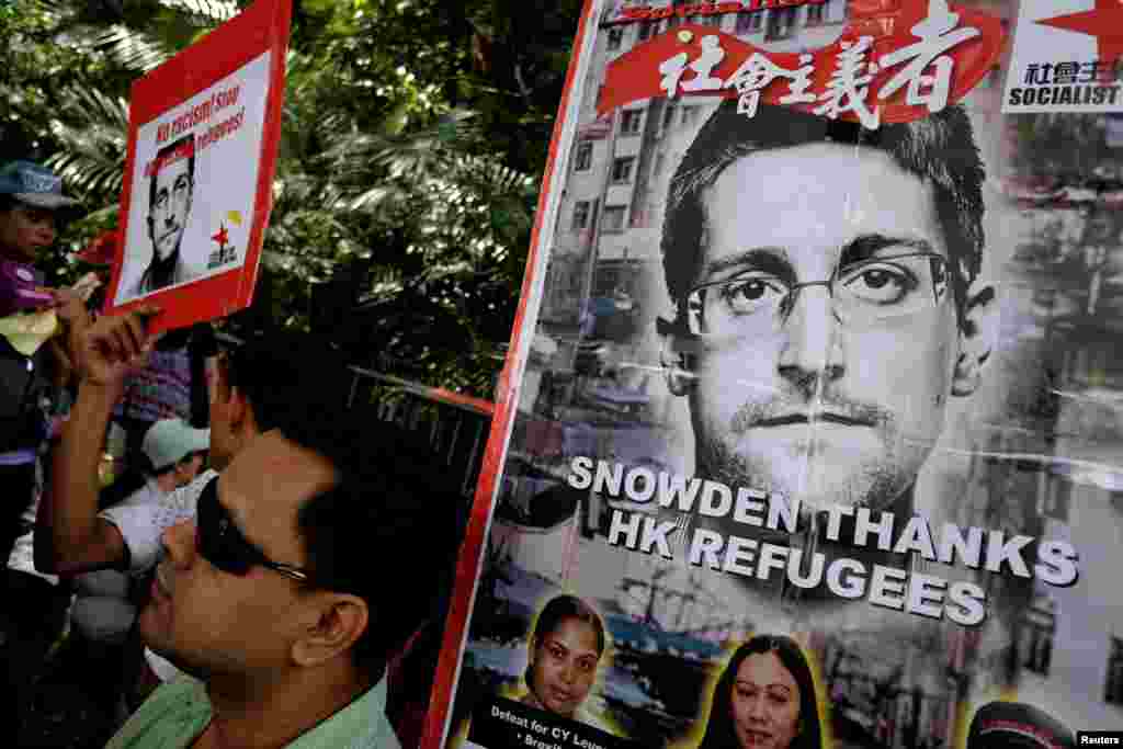 Refugees and protesters supporting Edward Snowden demonstrate outside the U.S. Consulate in Hong Kong, to demand that U.S. President Barack Obama grant Snowden a pardon.