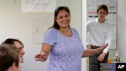 FILE - Democrat Manka Dhingra, a candidate for Washington state's 45th District Senate seat, talks with volunteers at her campaign headquarters in Redmond, Washington.