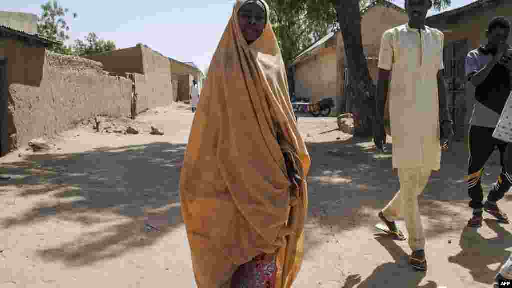 Une fille libérée par Boko Haram se promène avec son père à Dapchi, Nigeria, le 21 mars 2018.