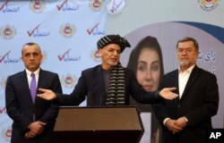 FILE - Afghan President Ashraf Ghani, center, speaks at the Afghan Independent Election Commission after receiving the official certificate of winning a 2nd term as president, in Kabul, Feb. 19, 2020.