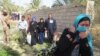 Iraqi pro-governement forces help people displaced from Islamic State (IS) group controlled areas close to Fallujah, on February 7, 2016.