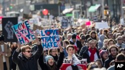 Demonstrators chant slogans as they march up Fifth Avenue in New York during a protest against the election of President-elect Donald Trump, Nov. 12, 2016.