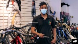 Noah Hicks, owner of Spokehouse Bikes in the Upham's Corner neighborhood of Boston, poses at his shop, June 24, 2020.