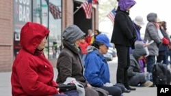 FILE - Practitioners of Falun Dafa, also called Falun Gong, meditate and exercise outside of the Chinese consulate, Thursday, April 25, 2019, in New York. Ping Li, 59, provided information to China about an individual affiliated with the Falun Gong movement.