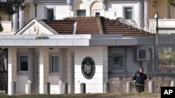 A police officer stands guard outside the U.S. embassy in Montenegro's capital Podgorica, Feb. 22, 2018.