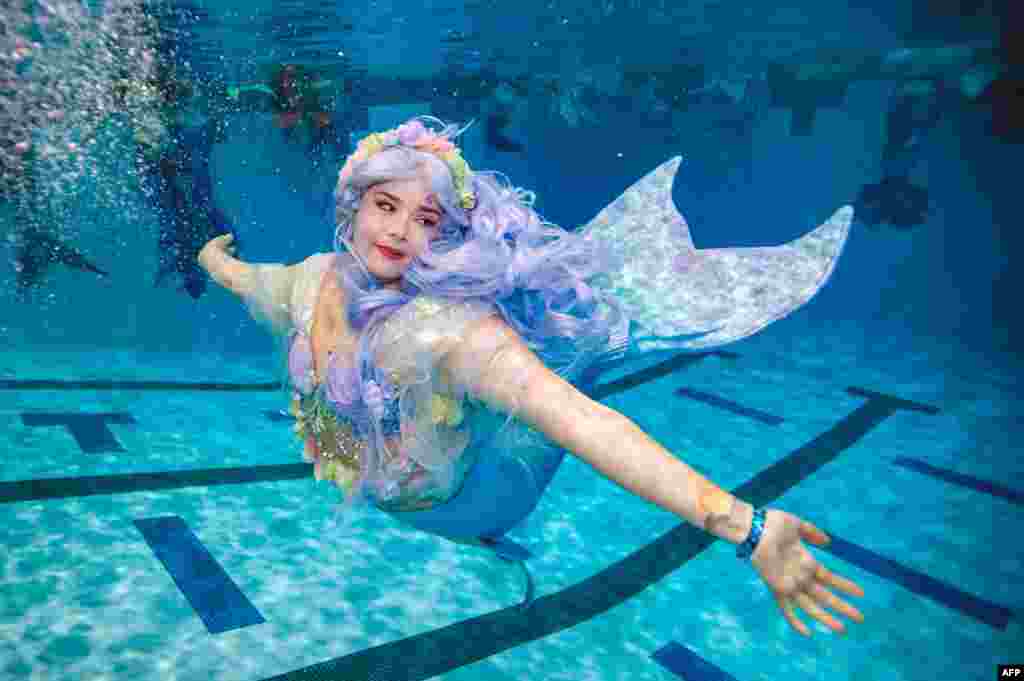 A mermaid swims during MerMagic Con at the Freedom Aquatic Center in Manassas, Virginia, Aug. 7, 2021.