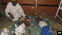 People are treated following suicide bomb attack at Government Science Technical College in Potiskum, Nigeria, Nov. 10, 2014.